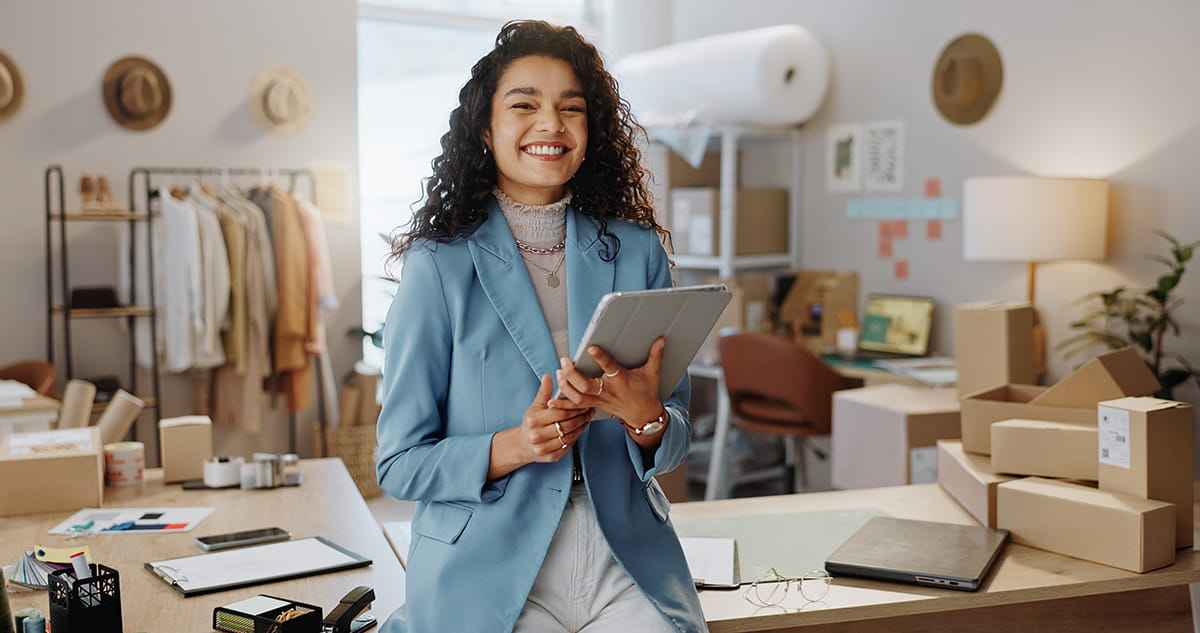 Young business woman holding a tablet and smiling