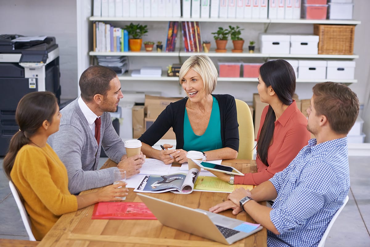Group of people having a meeting, smiling